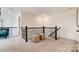 Open loft area with stylish railing and comfortable seating, perfect for relaxing or entertaining at 4230 Black Ct # 235, Harrisburg, NC 28075