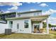 Back of the property with sliding glass doors leading to a covered patio area, and an AC unit sitting on the grass at 4230 Black Ct # 235, Harrisburg, NC 28075