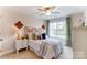 Bright bedroom with a ceiling fan, large window and charming decor accents create a cozy atmosphere at 4236 Black Ct # 234, Harrisburg, NC 28075