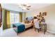 Comfortable bedroom with a bed, side table, desk, and a window providing natural light, creating a cozy space at 4236 Black Ct # 234, Harrisburg, NC 28075