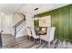 Dining room boasts modern lighting, decorative wall paneling and trim, and wood-look floors at 4236 Black Ct # 234, Harrisburg, NC 28075