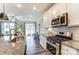 Bright kitchen features stainless appliances, granite counters, and opens to the living area at 4236 Black Ct # 234, Harrisburg, NC 28075