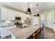 Bright kitchen features stainless appliances, granite counters, an island with seating, and wood-look floors at 4236 Black Ct # 234, Harrisburg, NC 28075
