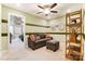 Comfortable living room featuring a ceiling fan, sofa, ottoman, and decorative accents, creating a welcoming atmosphere at 4236 Black Ct # 234, Harrisburg, NC 28075