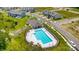 Aerial view featuring a community pool, playground, and parking area near residential homes at 4242 Black Ct # 233, Harrisburg, NC 28075