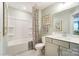 A bathroom featuring a shower-tub combo with patterned curtain, a single sink vanity and artwork at 4242 Black Ct # 233, Harrisburg, NC 28075