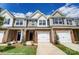 Charming townhome featuring a brick facade, white garage door and a well maintained lawn at 4242 Black Ct # 233, Harrisburg, NC 28075