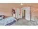 Bedroom showcasing neutral tones, carpet floors, closet, and access to additional spaces at 528 Mitchell Ave, Salisbury, NC 28144