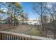 Backyard view from the deck featuring mature trees, lush lawn, lake view, and a boat dock at 5580 Crepe Myrtle Rd, York, SC 29745