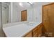 Bathroom features a large mirror, white countertops, wood cabinets and walk-in shower at 5580 Crepe Myrtle Rd, York, SC 29745