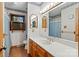 Well-lit bathroom with wood-framed mirrors, white countertops, and wood laminate flooring at 5580 Crepe Myrtle Rd, York, SC 29745
