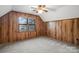 Wood-paneled bedroom featuring a ceiling fan and a window view of the lake at 5580 Crepe Myrtle Rd, York, SC 29745