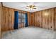 Wood-paneled bedroom with neutral carpet, window with blue drapes and ceiling fan at 5580 Crepe Myrtle Rd, York, SC 29745