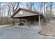 Open carport featuring a basketball hoop, lawn mower, concrete floor, wood posts, and an American flag at 5580 Crepe Myrtle Rd, York, SC 29745