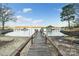Lakeside view from a sandy beach looking out at a boat dock and the serene lake at 5580 Crepe Myrtle Rd, York, SC 29745