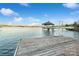 Beautiful lakeside view from a wooden dock, featuring clear water and a charming gazebo at 5580 Crepe Myrtle Rd, York, SC 29745