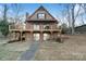 Charming brick home showcasing a spacious wooden deck, overlooking serene lake views at 5580 Crepe Myrtle Rd, York, SC 29745