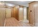 Inviting hallway with wood paneling, laminate flooring and direct access to the front door at 5580 Crepe Myrtle Rd, York, SC 29745