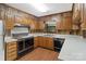 A vintage-style kitchen with wood cabinets, white countertops, and classic appliances at 5580 Crepe Myrtle Rd, York, SC 29745