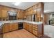Traditional-style kitchen features light wood cabinets, white countertops, and a classic black dishwasher at 5580 Crepe Myrtle Rd, York, SC 29745