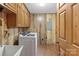 Functional laundry room equipped with washer and dryer, sink, and storage cabinets at 5580 Crepe Myrtle Rd, York, SC 29745