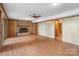 Spacious living room featuring a brick fireplace and wood laminate flooring at 5580 Crepe Myrtle Rd, York, SC 29745