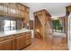 View of the living room, stairs, and kitchen featuring wood paneled walls and an exterior view at 5580 Crepe Myrtle Rd, York, SC 29745