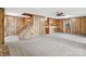 Spacious living room featuring stairs, neutral carpet, and wood paneled walls at 5580 Crepe Myrtle Rd, York, SC 29745