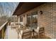 A cozy back porch featuring a seating area with a modern outdoor sofa set and a wood deck with access to the interior at 5580 Crepe Myrtle Rd, York, SC 29745