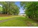 Grassy backyard leading to a private dock, highlighting the property's serene waterfront setting and access to the lake at 5580 Crepe Myrtle Rd, York, SC 29745