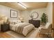 Bright bedroom with an accent chair, a plush bed with soft lighting, and simple decor at 5580 Crepe Myrtle Rd, York, SC 29745
