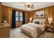 A charming bedroom with wood-paneled walls, a comfortable bed, and a cozy atmosphere enhanced by natural light at 5580 Crepe Myrtle Rd, York, SC 29745