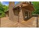 Spacious wooden deck with brick siding, great for outdoor entertaining with expansive views of the lush surroundings at 5580 Crepe Myrtle Rd, York, SC 29745