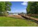 Lakefront home with a wooden dock, gazebo and boat in the background, providing a picturesque waterfront lifestyle at 5580 Crepe Myrtle Rd, York, SC 29745
