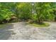 Wide driveway with a basketball court and carport surrounded by mature trees at 5580 Crepe Myrtle Rd, York, SC 29745