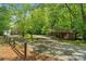 Long driveway leading to a home and covered carport, surrounded by mature trees that offer ample parking and shade at 5580 Crepe Myrtle Rd, York, SC 29745