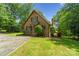 Charming brick home with a well-kept front lawn, mature trees, and a cozy deck, creating a welcoming curb appeal at 5580 Crepe Myrtle Rd, York, SC 29745