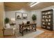 Modern office space with neutral colors, wood flooring, streamlined shelving and a decorative plant at 5580 Crepe Myrtle Rd, York, SC 29745