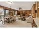 Spacious open concept living room with fireplace, wood paneling, dining area and plenty of natural light at 5580 Crepe Myrtle Rd, York, SC 29745