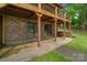 A covered brick patio with sliding glass doors, offering a cool outdoor space with a view of the backyard at 5580 Crepe Myrtle Rd, York, SC 29745