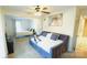 Comfortable bedroom featuring a daybed, queen-size bed, ceiling fan, and bright natural light at 7005 Stonington Ln, Charlotte, NC 28227