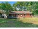 Back of house featuring a deck with exterior access at 711 E John St, Matthews, NC 28105