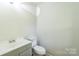 Bathroom featuring a vanity with storage and commode at 711 E John St, Matthews, NC 28105