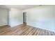 A bright, airy bedroom showcasing neutral walls and wood-look floors at 711 E John St, Matthews, NC 28105