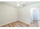 Bedroom with wood-look flooring, neutral walls and a white ceiling fan at 711 E John St, Matthews, NC 28105