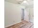 Bedroom with wood-look flooring, white trim, and white doors at 711 E John St, Matthews, NC 28105