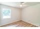 A light and airy bedroom features wood-look flooring and a bright window view at 711 E John St, Matthews, NC 28105