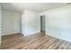 A light, airy bedroom with white walls and wood-look floors at 711 E John St, Matthews, NC 28105