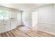 Kitchen showcasing white cabinets, stainless steel appliances, and wood-look floors at 711 E John St, Matthews, NC 28105