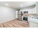 Modern kitchen features stainless steel appliances and light cabinets at 711 E John St, Matthews, NC 28105